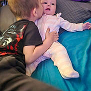 Elizabeth is registered to the contest to win money with this photo: affection, baby, bed, blanket, brother, child, clothing, comfort, cuddle, cute, face, family, head, indoor, kiss, person, pillow, sleepwear, stuffed_toy, toddler