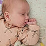 Elizabeth is registered to the contest to win money with this photo: baby, sleeping, infant, blanket, plush_toy, thumb_sucking, pink_clothing, cute, peaceful, face, head, soft_texture, bed, child, young, cozy, resting, indoors, person, closeup