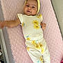 Analia Sucre joined the competition — help win amazing prizes! baby, infant, smile, yellow_headband, floral_outfit, pink_blanket, cute, lying_down, happy, child, soft_texture, indoors, person, headband, apparel, young_child, skin, face, playful, cozy
