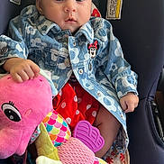 Analia Sucre joined the competition — help win amazing prizes! baby, child, car_seat, plush_toy, seahorse, jacket, denim, flower_pattern, polka_dots, red_skirt, cute, serious_expression, indoor, warning_label, seatbelt, sitting, person, infant, soft_toy, colorful