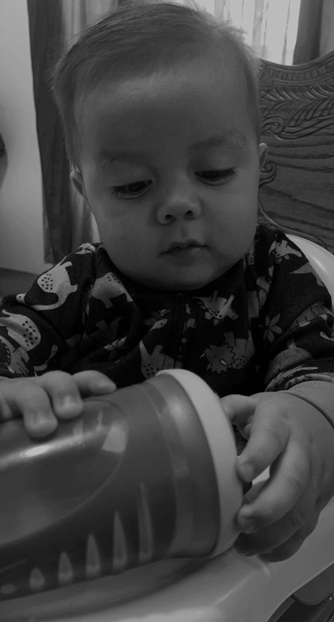 Eslan joined the competition — help win amazing prizes! arm, baby, baby_toddler_clothing, black, black_and_white, cheek, child, drinkware, facial_expression, finger, fun, hairstyle, hand, iris, mouth, nose, person, skin, standing, style