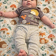 Joel joined the competition — help win amazing prizes! baby, infant, blanket, pattern, fox, hedgehog, mushroom, clothing, shirt, pants, feet, face, hair, lying_down, cute, cozy, soft, child, playful, indoors