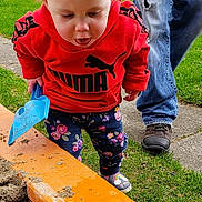 Charlee joined the competition — help win amazing prizes! toddler, child, earthworm, sandbox, plastic_shovel, red_hoodie, puma_logo, floral_pants, curious, outdoor, grass, adult, jeans, brown_shoes, sidewalk, nature, playtime, dirt, closeup, daylight
