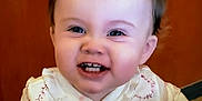 Charlee is registered to the contest to win money with this photo: baby, child, smiling, face, teeth, hair, ponytail, clothing, pattern, infant, happy, cute, portrait, indoor, person, young_child, closeup, skin, head, expression