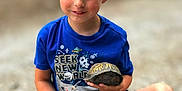 Asher joined the competition — help win amazing prizes! child, boy, turtle, blue_shirt, shorts, sitting, outdoor, gravel, smiling, nature, animal, casual_clothing, footwear, young, portrait, daylight, holding, cute, happy, leisure