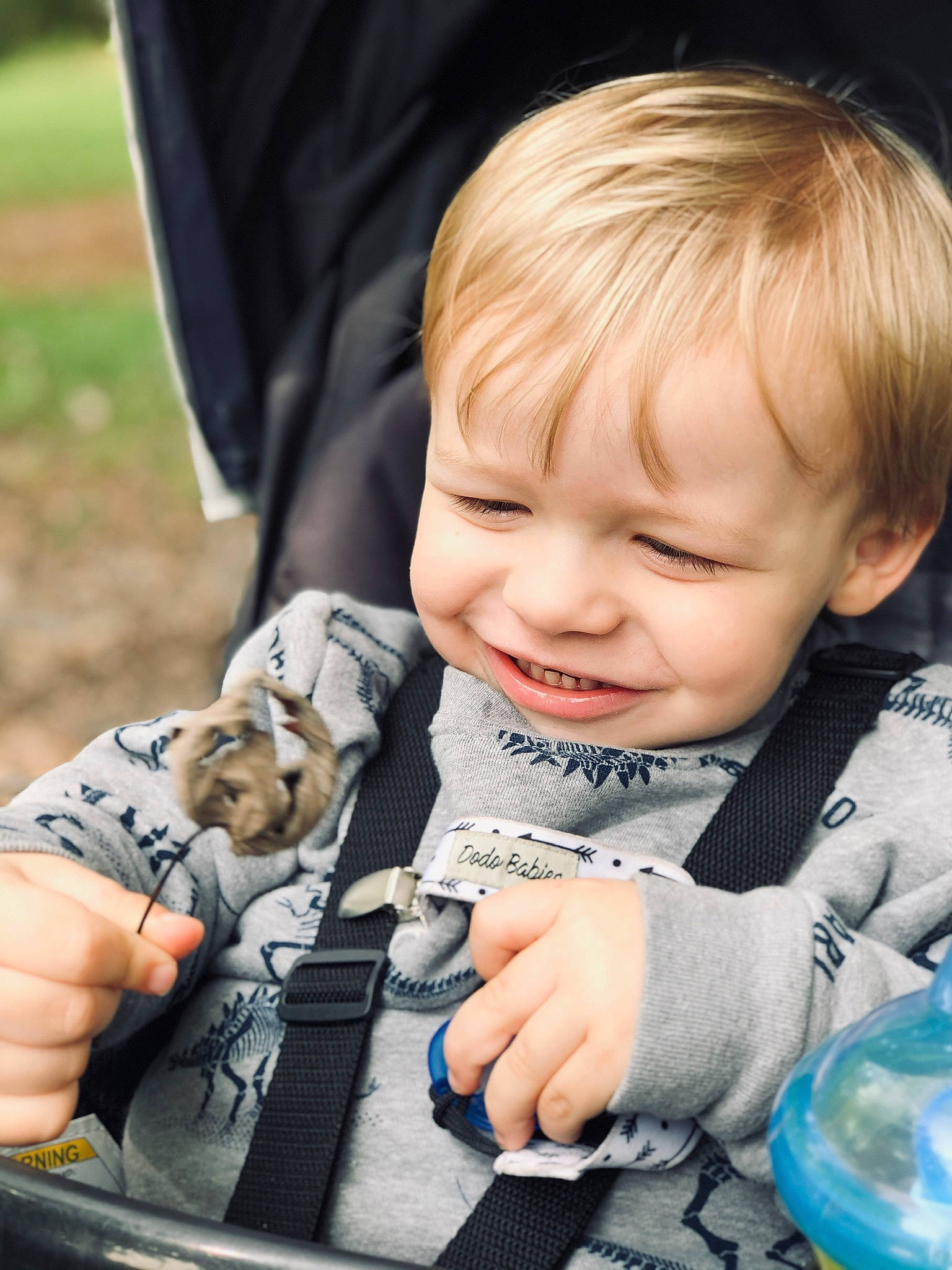Decklyn is registered to the contest to win money with this photo: baby, baby_products, baby_toddler_clothing, blue, cheek, child, eye, finger, fun, grass, hand, happy, iris, pattern, people, person, photograph, sitting, skin, smile
