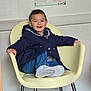 child, toddler, smiling, waiting_room, chair, jacket, denim, white_shoes, sneakers, poster, wallpaper, indoor, portrait, happy, hair, legs, metal_chair_legs, floor, clinic, seated