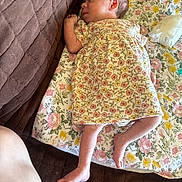 Karsyn joined the competition — help win amazing prizes! baby, brown_quilt, cozy, cute, diaper, floral_blanket, floral_dress, foot, hand, head, indoors, infant, lying_down, newborn, pacifier, peaceful, person, resting, skin, sleeping