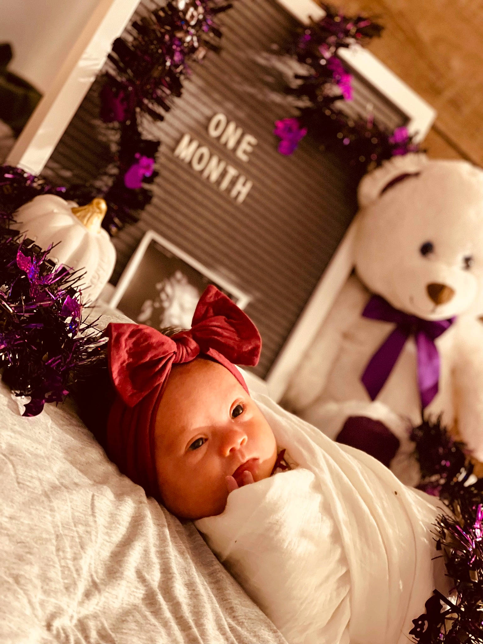Ella Joy is registered to the contest to win money with this photo: baby, baby_toddler_clothing, child, christmas_decoration, comfort, cut_flowers, decoration, event, floral_design, flower_arranging, happy, headwear, magenta, ornament, person, petal, pink, plant, purple, room