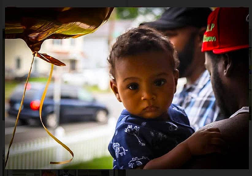 Dazean Jr is registered to the contest to win money with this photo: audio_equipment, automotive_lighting, baseball_cap, cable, cap, car, child, fun, happy, hat, headwear, leisure, person, road, smile, street, t_shirt, temple, toddler, toy
