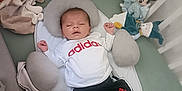 Tony participe au concours pour gagner de l'argent avec cette photo : adidas, baby, black_shorts, blanket, blue_socks, child, clothing, cozy, crib, cute, indoors, infant, mickey_mouse, pillow, resting, sleeping, soft_toys, stuffed_animals, teddy_bear, white_shirt
