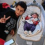 Tony a rejoint le concours — aidez-le/la à gagner de superbes lots ! baby, baby_bed, bed, blanket, child, clothing, cute, family, home, indoor, infant, lying_down, pajamas, peace, peace_sign, person, portrait, resting, sleeping, smartphone