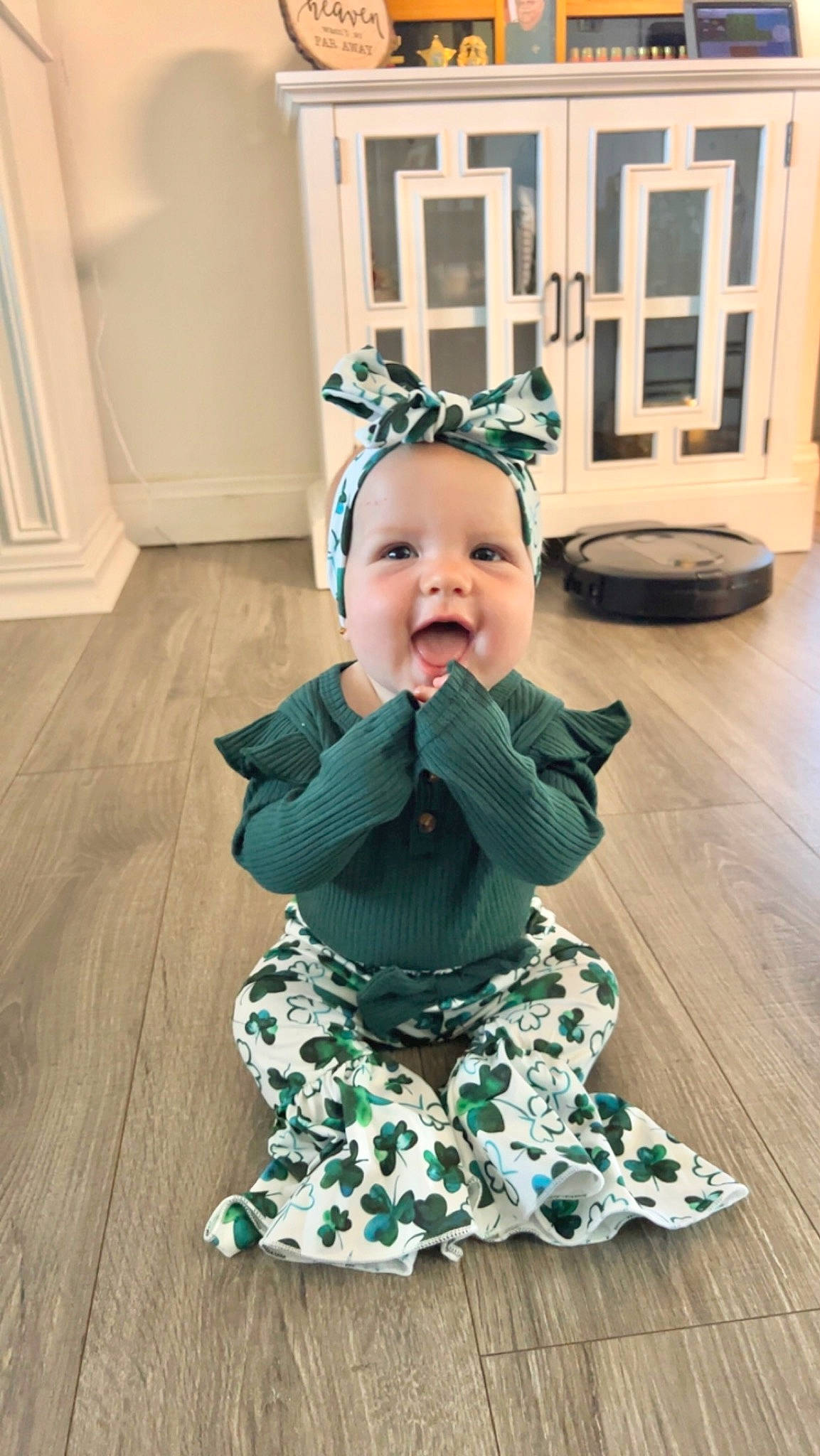 Saydie is registered to the contest to win money with this photo: baby, baby_toddler_clothing, child, dress, face, facial_expression, floor, flooring, happy, hardwood, head, headgear, pattern, person, pink, purple, sleeve, smile, standing, toddler