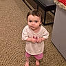 toddler, child, indoor, carpet, barefoot, curious, pink_shorts, white_tshirt, bench, textile, colorful, floor, standing, young_child, person, portrait, looking_up, casual_clothing, room, home
