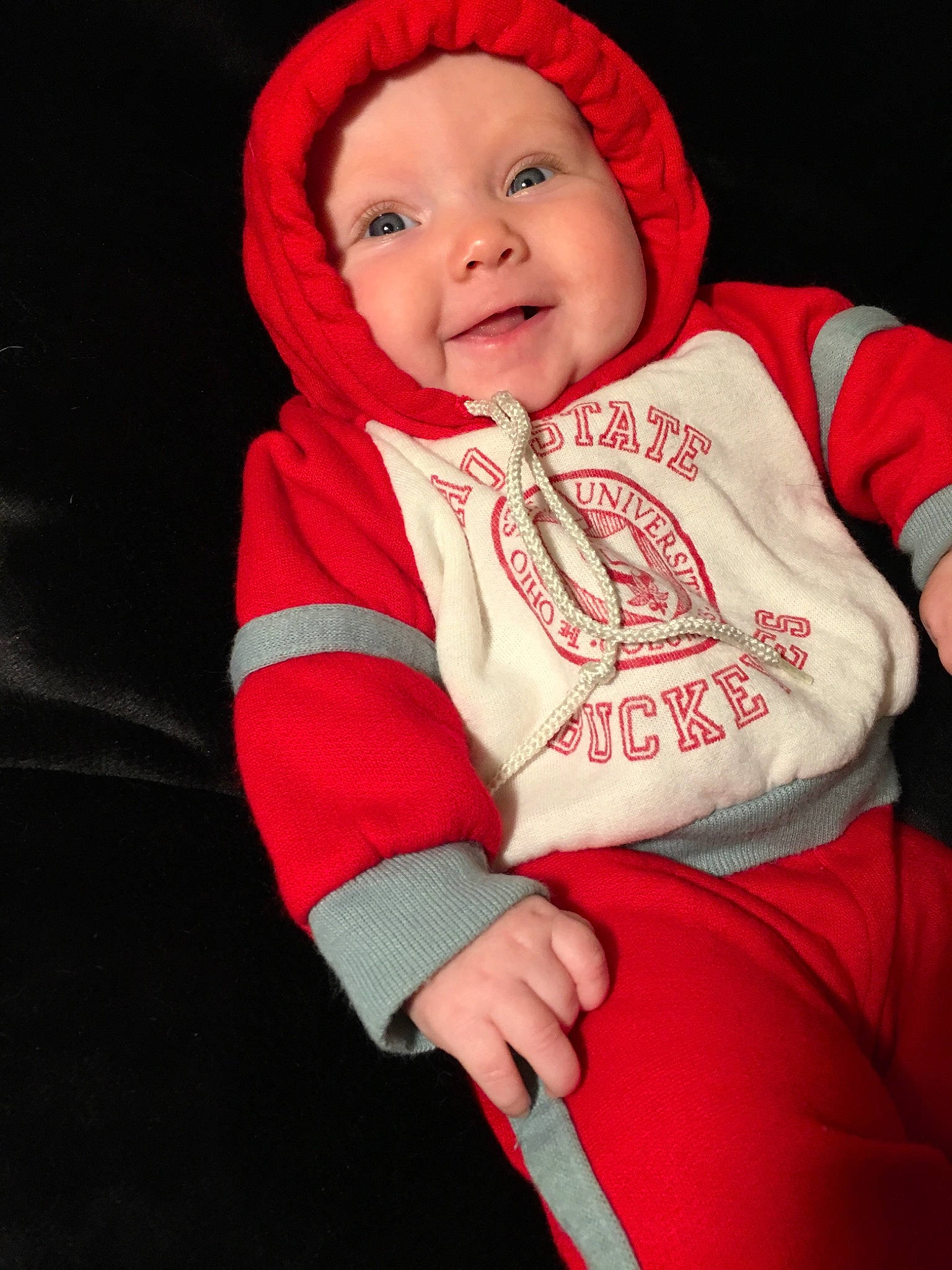 Stevie is registered to the contest to win money with this photo: baby, cheek, child, hood, hoodie, jacket, outerwear, person, pink, product, red, skin, smile, toddler