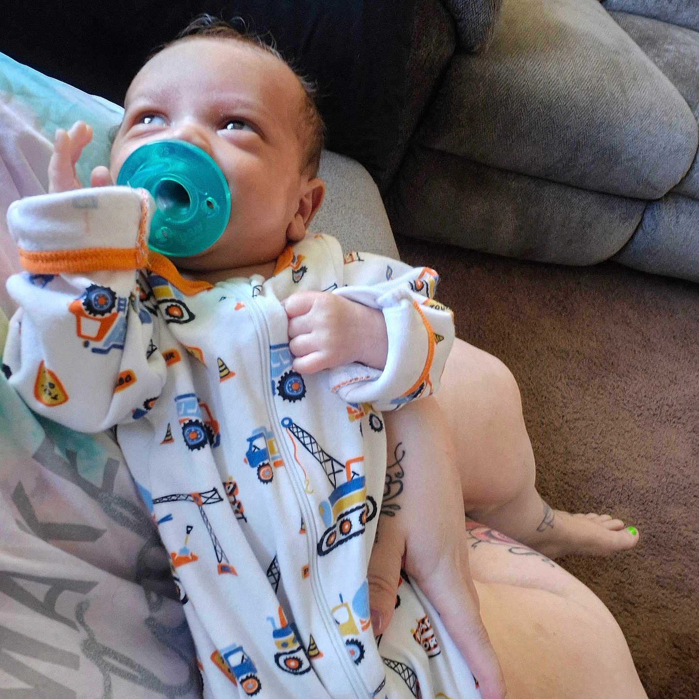 Ragnar joined the competition — help win amazing prizes! baby, pacifier, onesie, infant, person, couch, carpet, hand, foot, tattoo, clothing, indoor, cute, child, face, looking_up, holding, fabric, sleeve, comfort