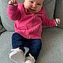 baby, infant, child, smiling, portrait, pink_jacket, jeans, white_shoes, sofa, cushion, upholstery, arm, hand, feet, happy, cute, casual_clothing, zipper, closeup, indoor