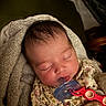 Auriella is registered to the contest to win money with this photo: baby, blanket, child, comfort, cozy, cute, face, floral_clothing, head, indoors, infant, newborn, pacifier, peaceful, person, resting, sleeping, soft_texture, towel, warm