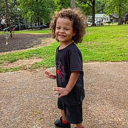 Marcus joined the competition — help win amazing prizes! black_clothing, child, curly_hair, daytime, fun, grass, happy, nature, outdoor, park, person, play, playground, red_socks, shoes, shorts, sidewalk, smiling, trees, tshirt