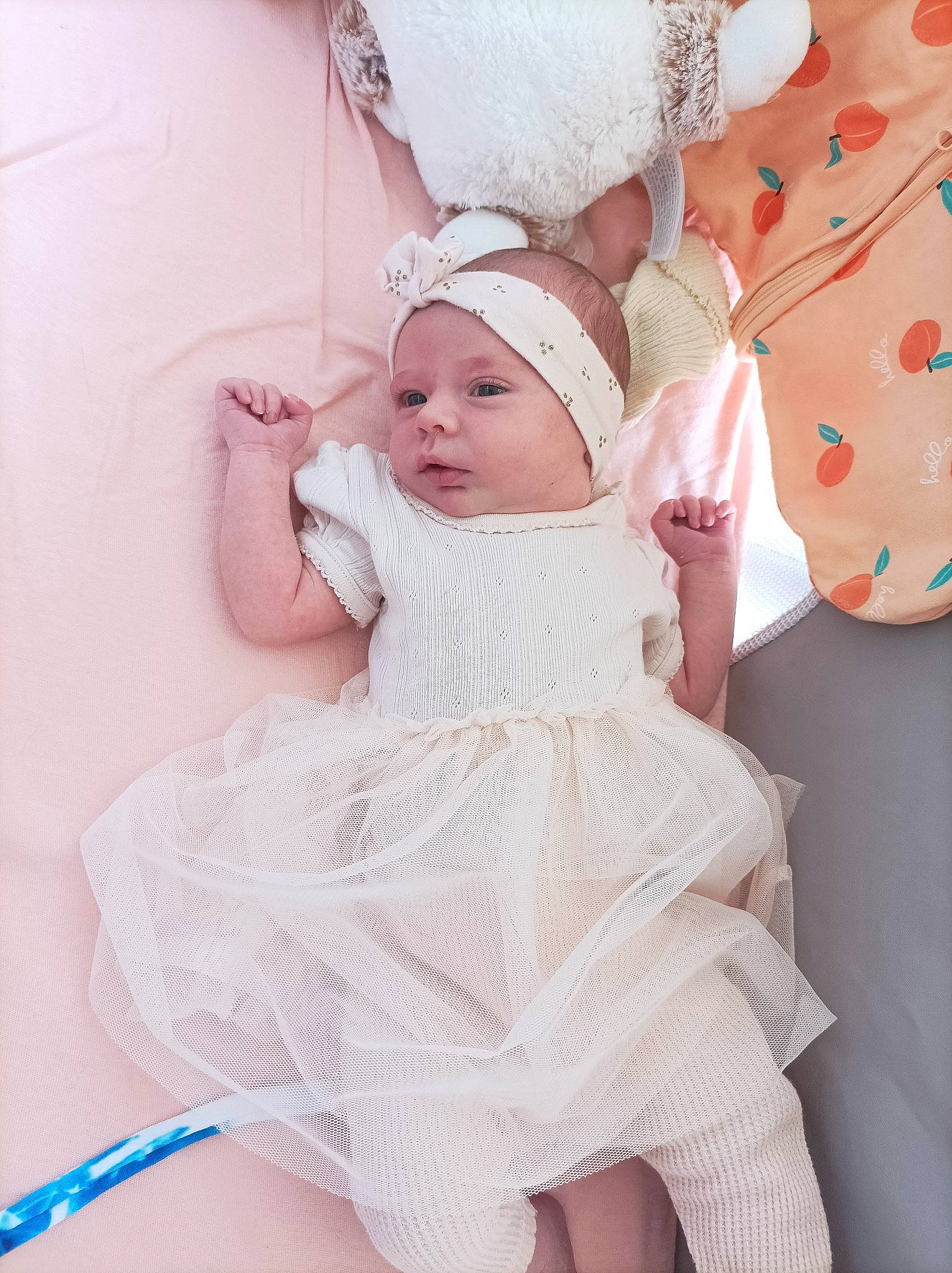 Norah participe au concours pour gagner de l'argent avec cette photo : baby, baby_toddler_clothing, bridal_accessory, child, comfort, costume, dress, embellishment, event, eyelash, fashion_design, happy, head, headgear, headpiece, headwear, person, pink, skin, sleeve