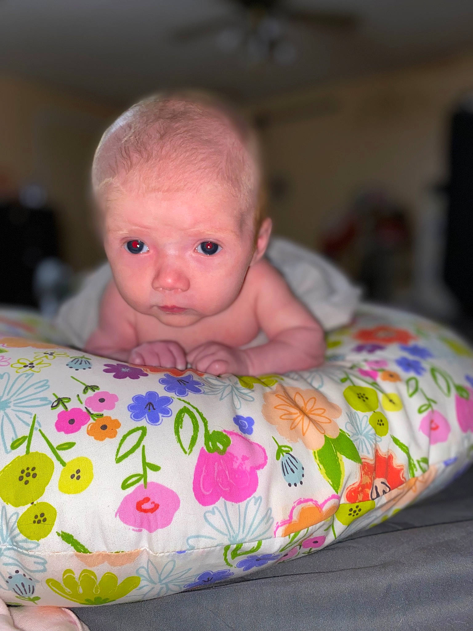 Brylee is registered to the contest to win money with this photo: arm, baby, baby_products, baby_toddler_clothing, bed_sheet, bedding, bedtime, cheek, child, comfort, flooring, happy, linens, mouth, person, room, sitting, skin, toddler, tummy_time