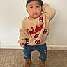 toddler, child, baby, portrait, standing, indoors, sweater, cap, jeans, boots, fashion, cute, serious_expression, hand_on_head, carpet, wall, clothing, full_body, photography, spiderman