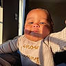 Zion joined the competition — help win amazing prizes! baby, infant, child, portrait, face, indoors, sunlight, window, sweater, knitwear, closeup, looking_at_camera, serious_expression, cozy, human, person, photography, warm_lighting, home, hand