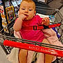 Blanche joined the competition — help win amazing prizes! baby, shopping_cart, blanket, grocery_store, red_strap, child, infant, pink_clothing, sitting, furniture, hand, face, foot, supermarket, retail, safety_belt, food_products, aisle, person, cute