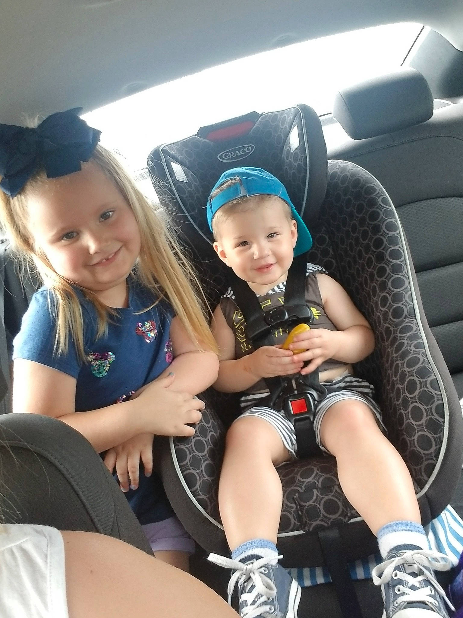 Ameilia joined the competition — help win amazing prizes! auto_part, black_hair, car, car_seat, child, family_car, joy, leg, luxury_vehicle, person, sitting, smile, steering_wheel, thigh, toddler, vacation, vehicle