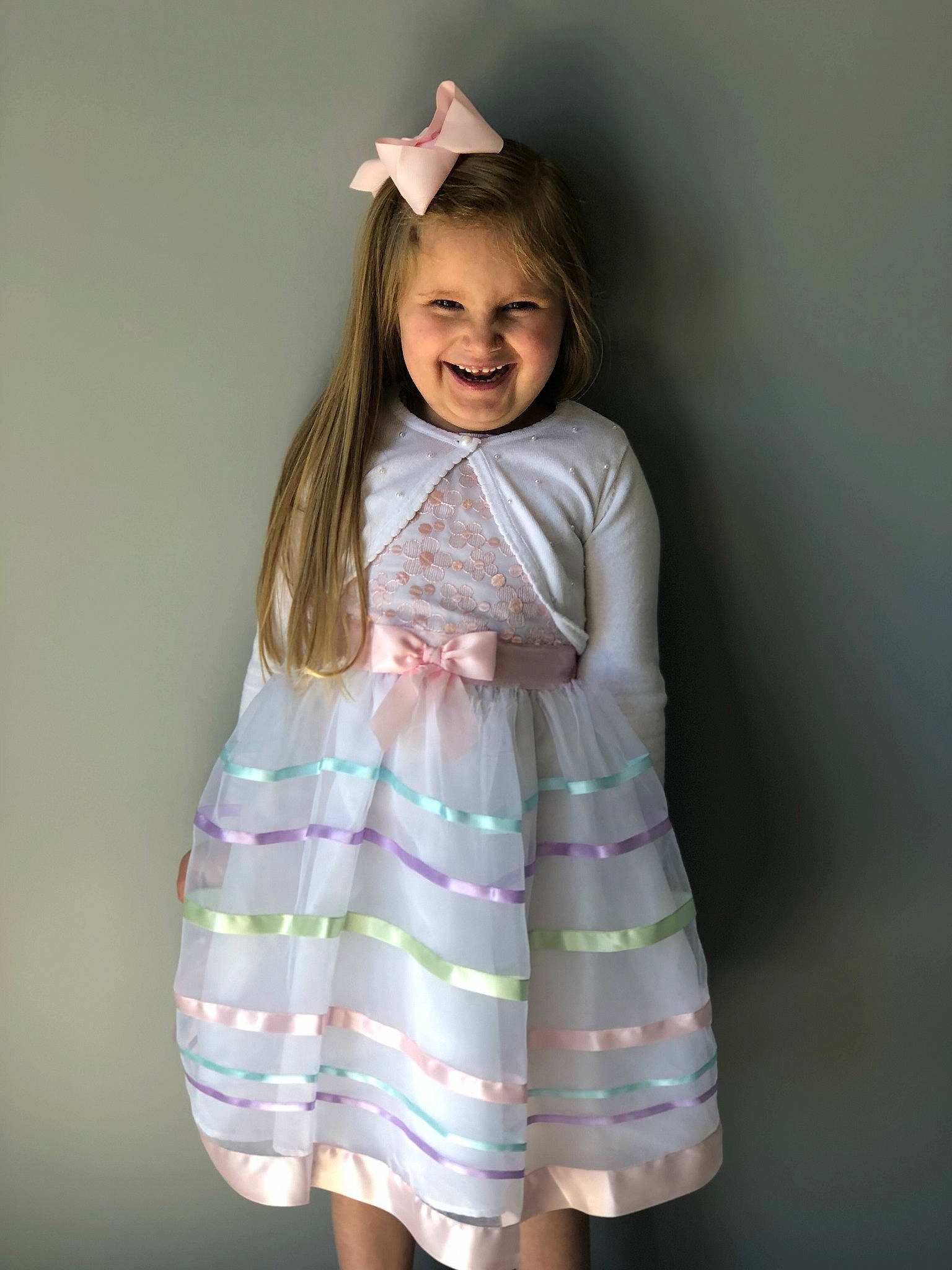 Ameilia is registered to the contest to win money with this photo: abdomen, brown_hair, child, child_model, clothing, dress, joy, pattern, person, pink, skin, sleeve, smile, textile, toddler, trunk, white