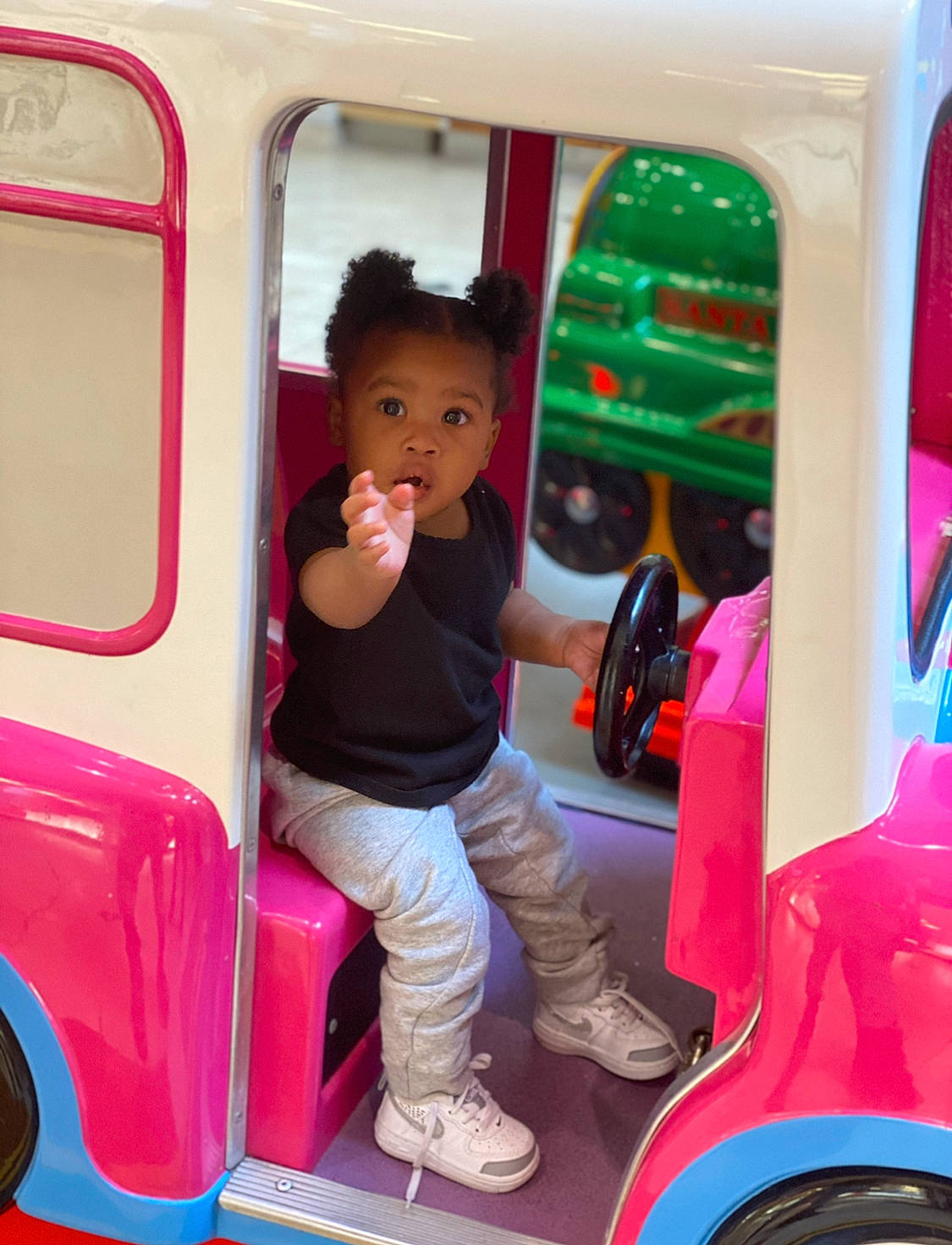 Avah is registered to the contest to win money with this photo: automotive_design, automotive_exterior, bumper, child, fun, leisure, mode_of_transport, motor_vehicle, person, pink, product, public_space, riding_toy, sneakers, surprise, tire, toddler, travel, vehicle, vehicle_door