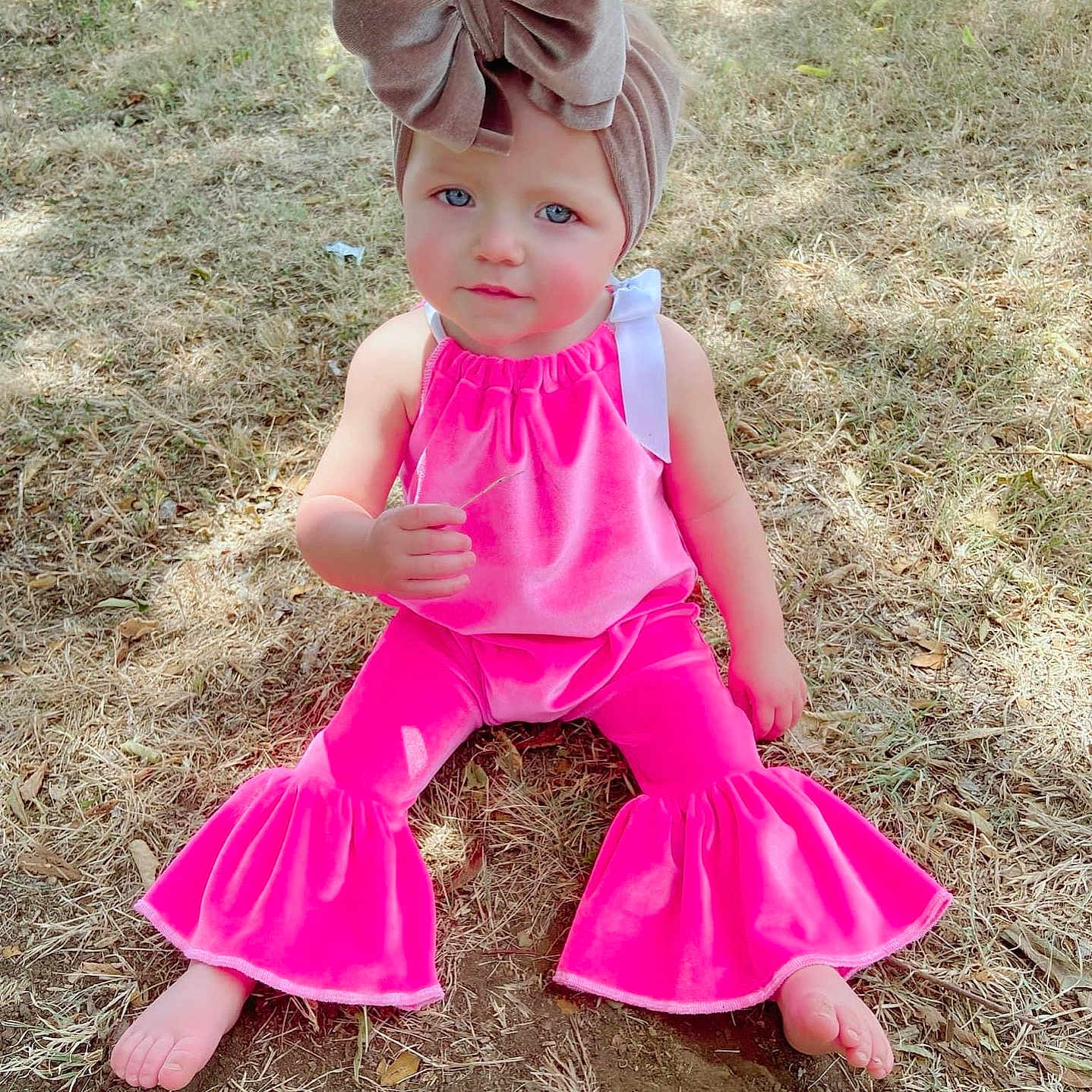 Whitley joined the competition — help win amazing prizes! bodypart, child, clothing, costume, dress, face, female, finger, footwear, girl, grass, hand, hat, head, person, photography, plant, portrait, sandal, sitting