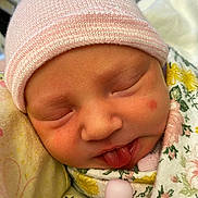 Paislee is registered to the contest to win money with this photo: newborn, baby, sleeping, face, hat, pink, blanket, floral, cute, tongue, peaceful, closeup, infant, soft, skin, wrapped, child, adorable, portrait, resting