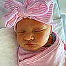 Paislee is registered to the contest to win money with this photo: newborn, baby, sleeping, pink, bow, hat, blanket, swaddled, infant, cute, peaceful, closeup, portrait, soft, cozy, child, headwear, resting, indoors, babyclothes