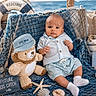 Alexander is registered to the contest to win money with this photo: baby, teddy_bear, fishing_rod, nautical_theme, seashell, starfish, sign, boat, ocean, net, blue_clothing, sock, child, soft_toy, summer, outdoor, cute, decor, hat, water