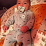 Milo is registered to the contest to win money with this photo: baby, pacifier, blanket, onesie, infant, cute, sleepwear, whale_print, soft_toys, comfortable, child, indoor, portrait, young, cozy, clothing, smiling, resting, home, relaxed