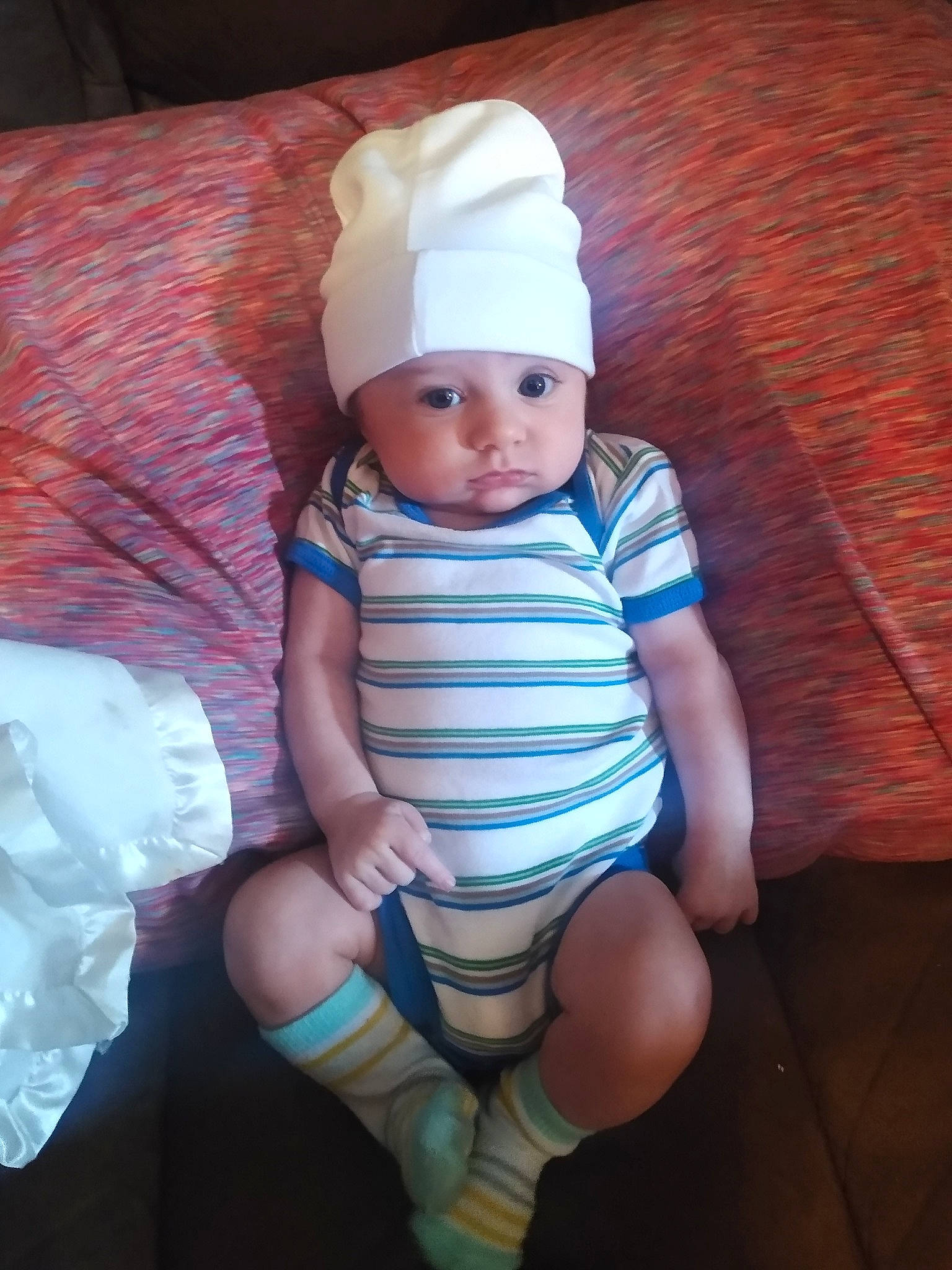 Zyad is registered to the contest to win money with this photo: baby, baby_toddler_clothing, electric_blue, eye, face, finger, foot, hat, headwear, human_body, human_leg, iris, knee, leg, pattern, person, skin, sleeve, thigh, thumb