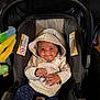 apparel, baby, car_seat, child, clothing, comfort, cozy, cute, fabric, happy, hoodie, indoor, infant, person, playful, seatbelt, sitting, small_hands, smile, toy