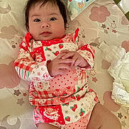Gracelynn joined the competition — help win amazing prizes! baby, infant, child, face, hair, hands, clothing, patterned_outfit, strawberry, bed, bedding, pillow, diaper, cute, indoors, laying_down, expression, skin, person, young