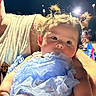Gracelynn joined the competition — help win amazing prizes! baby, child, infant, person, blue_dress, pigtails, hair, cute, portrait, night, lights, adult, holding, arm, skin, face, eyes, clothing, outdoor, expression