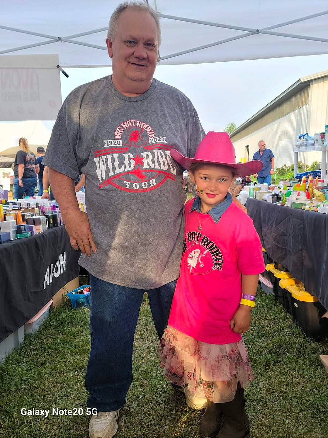 Dixie is registered to the contest to win money with this photo: baseball_cap, cap, event, eyewear, fun, grass, happy, hat, headwear, joy, leisure, mammal, person, pink, plant, recreation, shorts, sky, smile, sun_hat