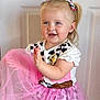 Darcey joined the competition — help win amazing prizes! blonde_hair, blue_eyes, child, clapping, cow_print, cute, door, dress_up, fashion, girl, happy, indoor, person, pigtails, pink_tutu, playful, portrait, sheriff_badge, smiling, toddler