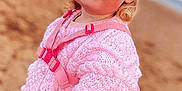 Darcey joined the competition — help win amazing prizes! beach, blonde_hair, blue_eyes, child, clothing, curly_hair, cute, daylight, fashion, happy, nature, outdoor, person, pink_skirt, pink_sweater, portrait, sand, smile, toddler, young_child