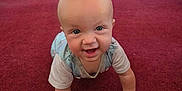 Colton joined the competition — help win amazing prizes! baby, crawling, carpet, indoor, smiling, child, cute, face, hands, wooden_bench, red_carpet, window, natural_light, infant, happy, person, floor, room, young_child, casual_clothing