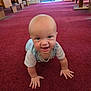 baby, crawling, carpet, indoor, smiling, child, cute, face, hands, wooden_bench, red_carpet, window, natural_light, infant, happy, person, floor, room, young_child, casual_clothing