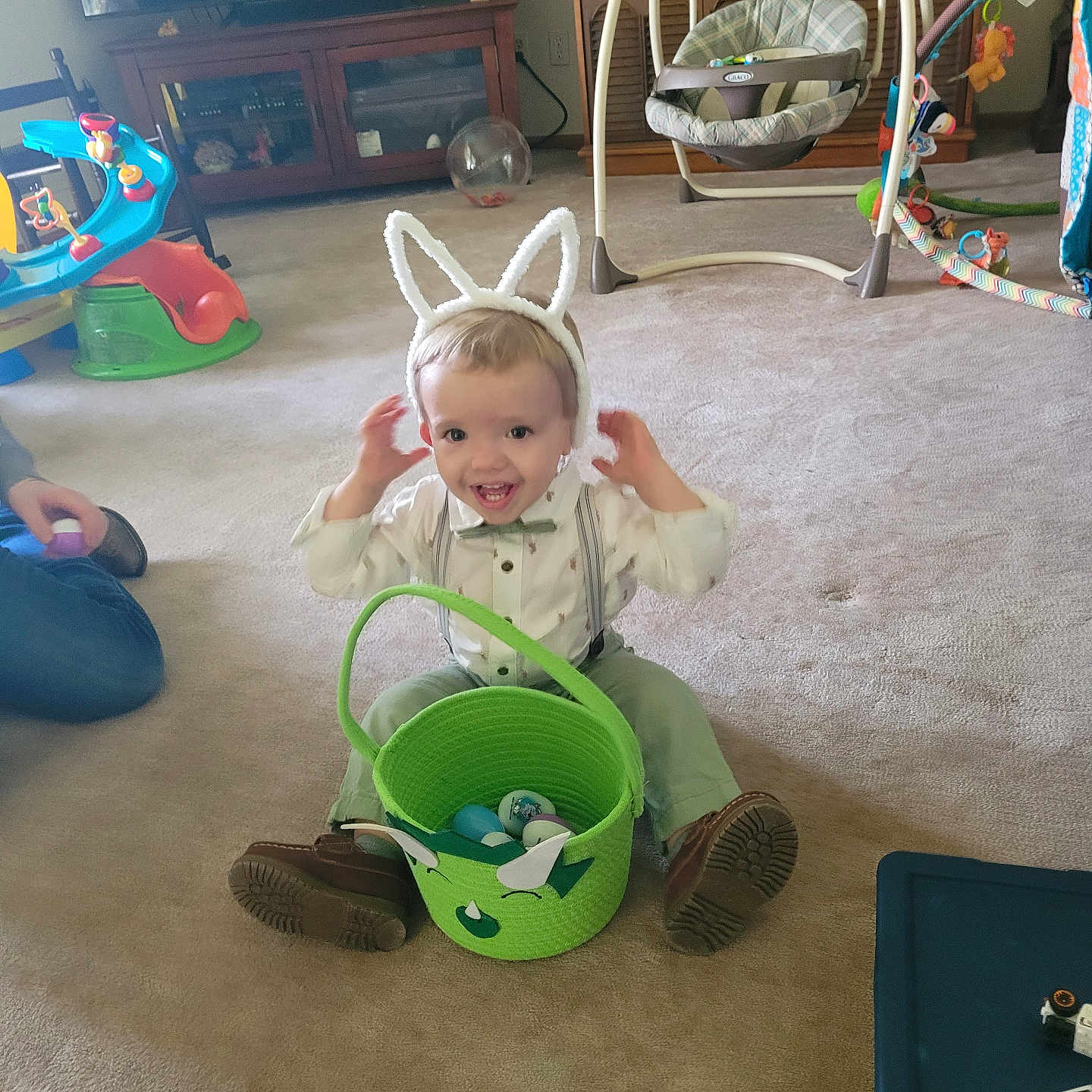 Gabriel joined the competition — help win amazing prizes! baby_swing, bow_tie, bunny_ears, cabinet, carpet, child, easter_basket, furniture, happy, home, indoor, person, plastic_eggs, play_area, shoes, smiling, suspenders, television, toddler, toy