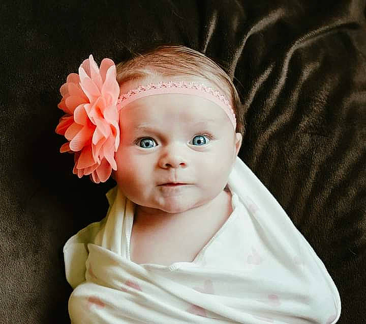 Esther is registered to the contest to win money with this photo: baby, baby_products, baby_toddler_clothing, bridal_accessory, cheek, child, comfort, fashion_accessory, flower, hair_accessory, head, headband, headgear, headpiece, peach, person, petal, plant, rose_family, sleeve