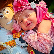 Esmeralda joined the competition — help win amazing prizes! newborn, baby, sleeping, infant, pink_bow, headband, plush_toy, stuffed_animal, smiling, portrait, close_up, cozy, blanket, pacifier, nursery, colorful, soft_lighting, lying_down, child, indoors