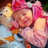 newborn, baby, sleeping, infant, pink_bow, headband, plush_toy, stuffed_animal, smiling, portrait, close_up, cozy, blanket, pacifier, nursery, colorful, soft_lighting, lying_down, child, indoors