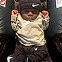 Alijah joined the competition — help win amazing prizes! baby, infant, car_seat, nike, clothing, hat, footwear, sleeping, child, cute, fashion, apparel, black, gray, infant_clothing, indoor, portrait, relaxing, newborn, person